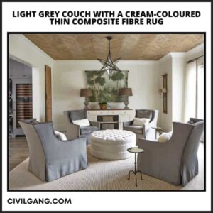 Light Grey Couch with a Cream-Coloured Thin Composite Fibre Rug
